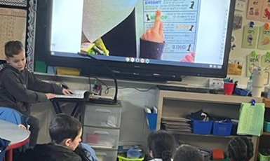  student shares his work with the class